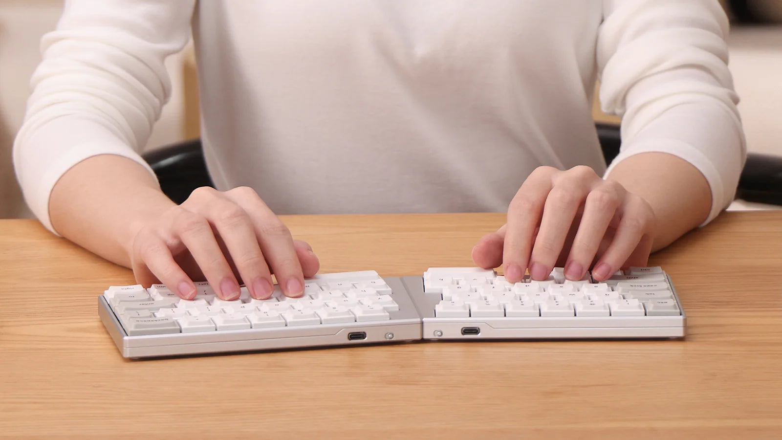 A detailed studio render of the ElimKeys Elytra silver and white split mechanical keyboard halves on a white background, viewed from an elevated front-right angle.
