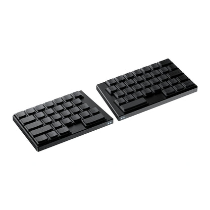 Angled studio shot of the black ElimKeys Elytra split mechanical keyboard, featuring blank low-profile keycaps separated on a pure white background.