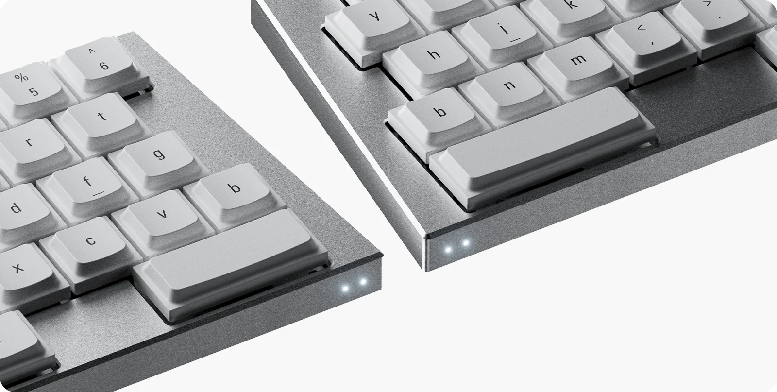 A macro close-up of the silver ElimKeys Elytra split mechanical keyboard, highlighting the dual white LED indicator lights on the corners and the premium bead-blasted aluminum finish.
